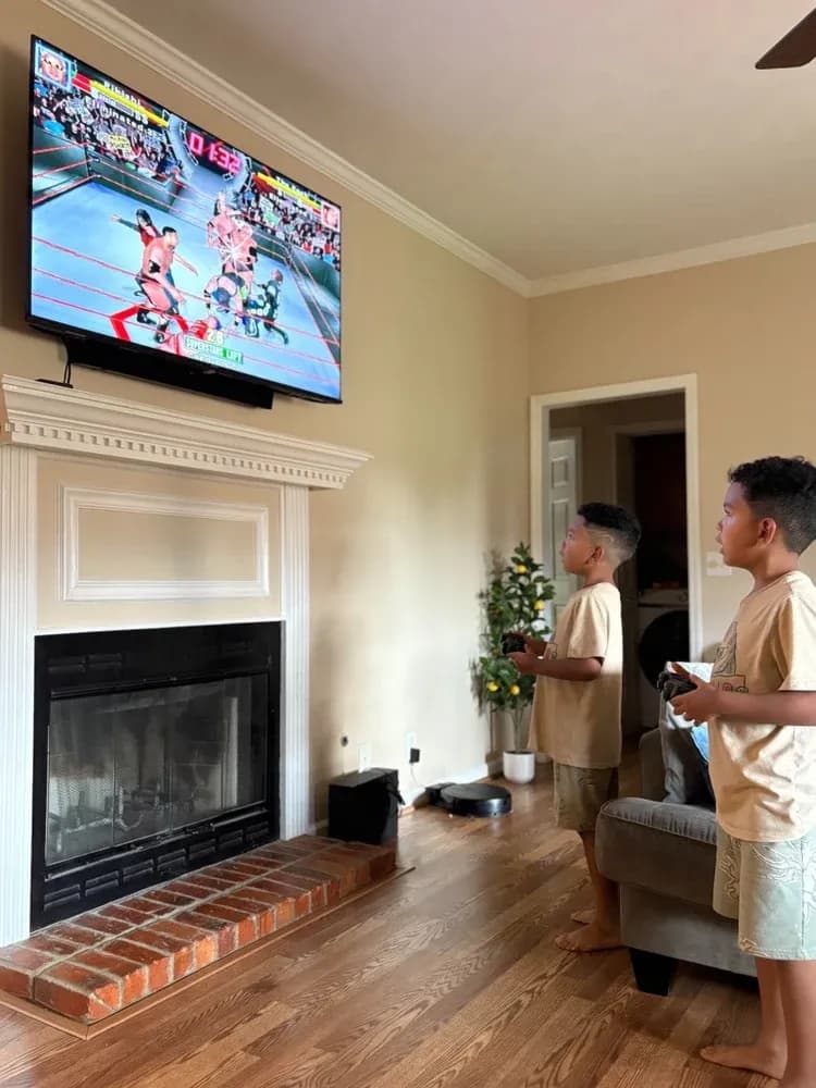 Two kids playing the PixelPlay G11 Pro on the living-room TV